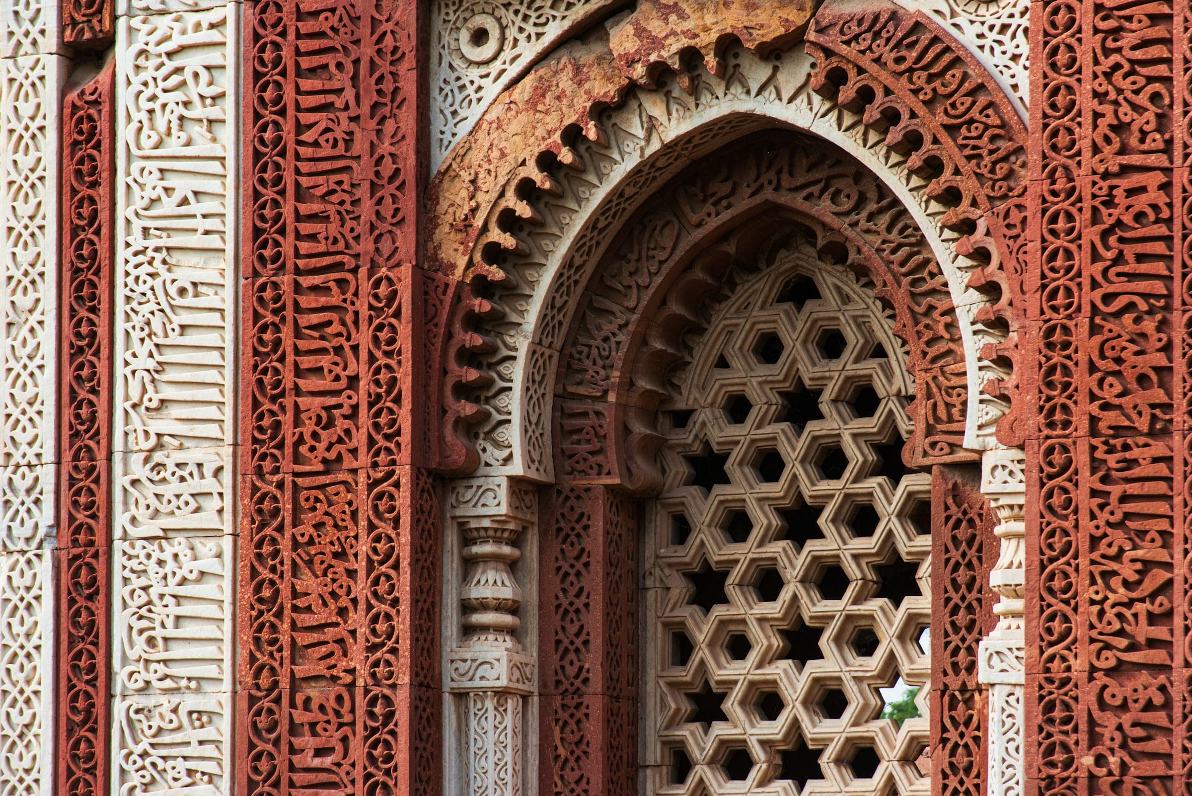 Carved Islamic geometric patterns on a historic sandstone facade